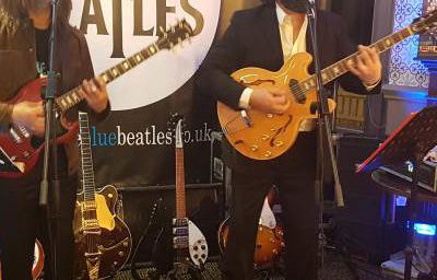 The Blue Beatles Duo performing in late era costumes