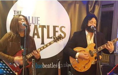 The Blue Beatles Duo performing in late era costumes