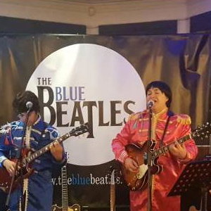 The Blue Beatles Duo performing in Sgt Pepper uniforms