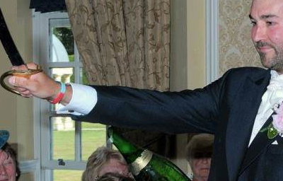 The Groom Takes Charge of the 'Sabrage'
