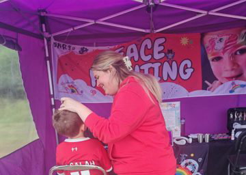 Rainbow Faces Ltd staff in action, face painter