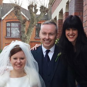 A photo with the bride and groom after the service