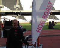 Anna holding the Hog Roast Sign at Olympic Stadium