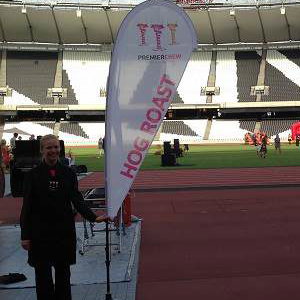 Anna holding the Hog Roast Sign at Olympic Stadium
