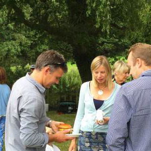 Queue for truck at farmhouse summer party