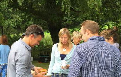 Queue for truck at farmhouse summer party