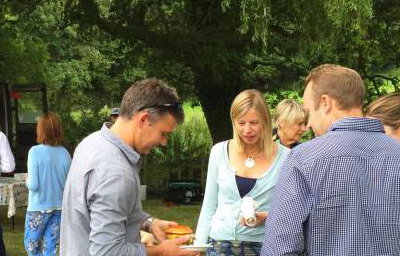 Queue for truck at farmhouse summer party