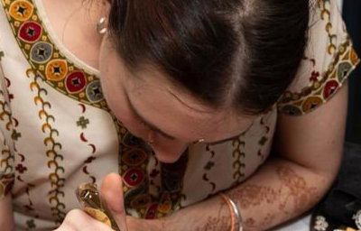 Henna being applied for a wedding guest