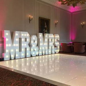 The stunning Crathorne Hall Hotel with one of our gloss white Led Starlit dance floors and our giant Led Mr & Mrs with blush pink uplighting.