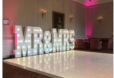 The stunning Crathorne Hall Hotel with one of our gloss white Led Starlit dance floors and our giant Led Mr & Mrs with blush pink uplighting.