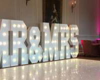 The stunning Crathorne Hall Hotel with one of our gloss white Led Starlit dance floors and our giant Led Mr & Mrs with blush pink uplighting.