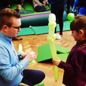 Making a dinosaur with a helper at a birthday party