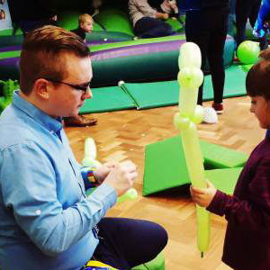 Making a dinosaur with a helper at a birthday party
