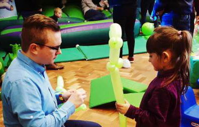 Making a dinosaur with a helper at a birthday party