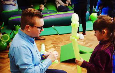 Making a dinosaur with a helper at a birthday party