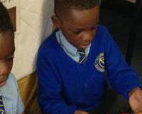 A very brave pupil holding Yazzoo the milk snake