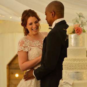 Bride and groom with their wedding cake 