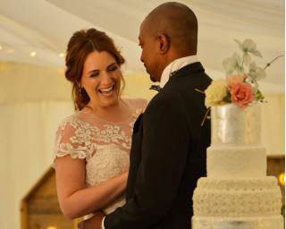 Bride and groom with their wedding cake 