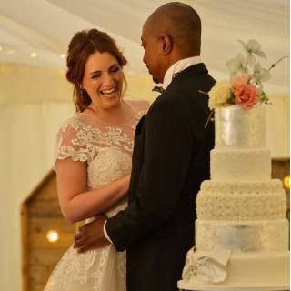 Bride and groom with their wedding cake 