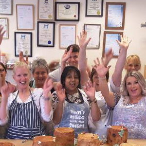 Group of pupils cheering after finishing their chocolate workshop.
