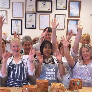 Group of pupils cheering after finishing their chocolate workshop.