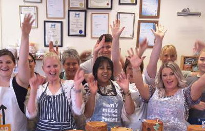 Group of pupils cheering after finishing their chocolate workshop.