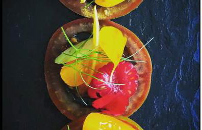 Tomatoes and edible flowers from the kitchen garden. Canapé