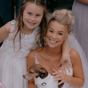 Bride posing with a surprise guest and her daughter