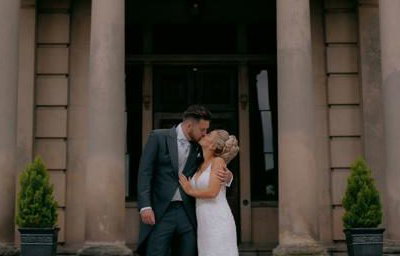 Bride and Groom kissing outdoors
