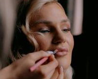 Bride having makeup applied during Bridal Preparations
