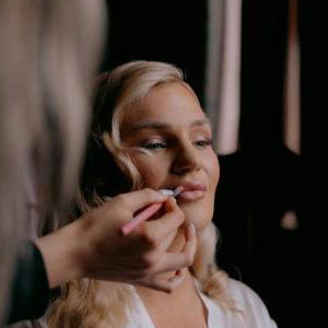 Bride having makeup applied during Bridal Preparations