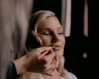 Bride having makeup applied during Bridal Preparations