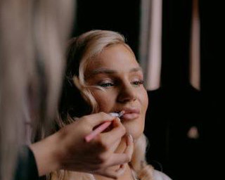Bride having makeup applied during Bridal Preparations