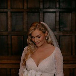 Bride looking at boquet before ceremony