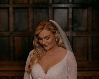 Bride looking at boquet before ceremony