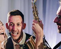 Saxophonist with bride and groom