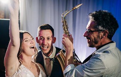 Saxophonist with bride and groom