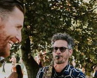 Saxophonist with bride and groom